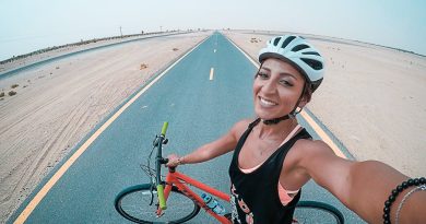How to Use the iPhone Health App: Monitor Your Health and Fitness woman holding bicycle on asphalt road